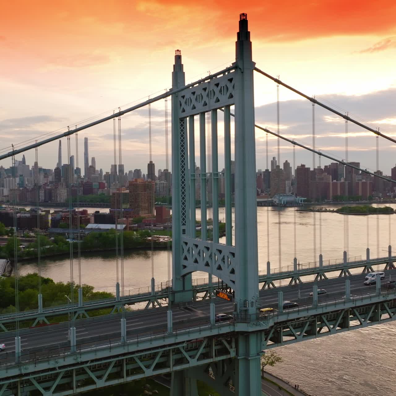 Beautiful structure of Triborough bridge with quick traffic. Amazing bridge structure at the backdrop of cityscape under the pink sky