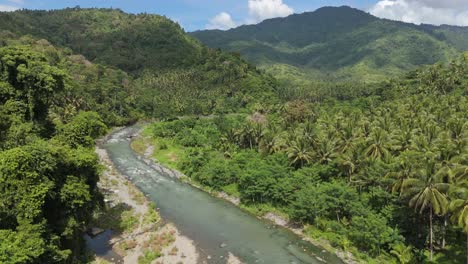 drone flight along santiago river amidst tropical jungle in philippines