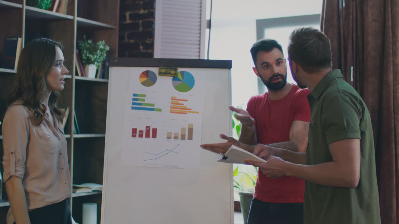 Businesswoman with megaphone shouting at agruing team