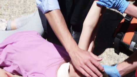 paramedics examining injured girl