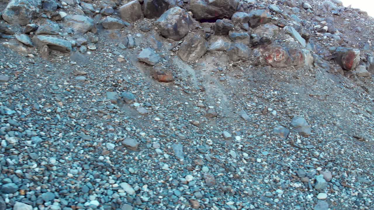 Slow pan along gravel and rocks