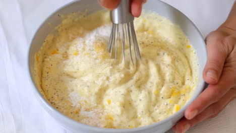 hands whisking ingredients in a bowl