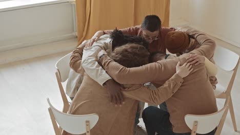 group of people hugging in circle