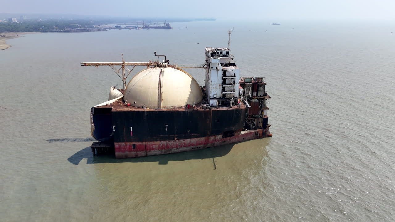 Epic cinematic aerial shot of a large ship abandoned in a ship graveyard in Bangladesh
