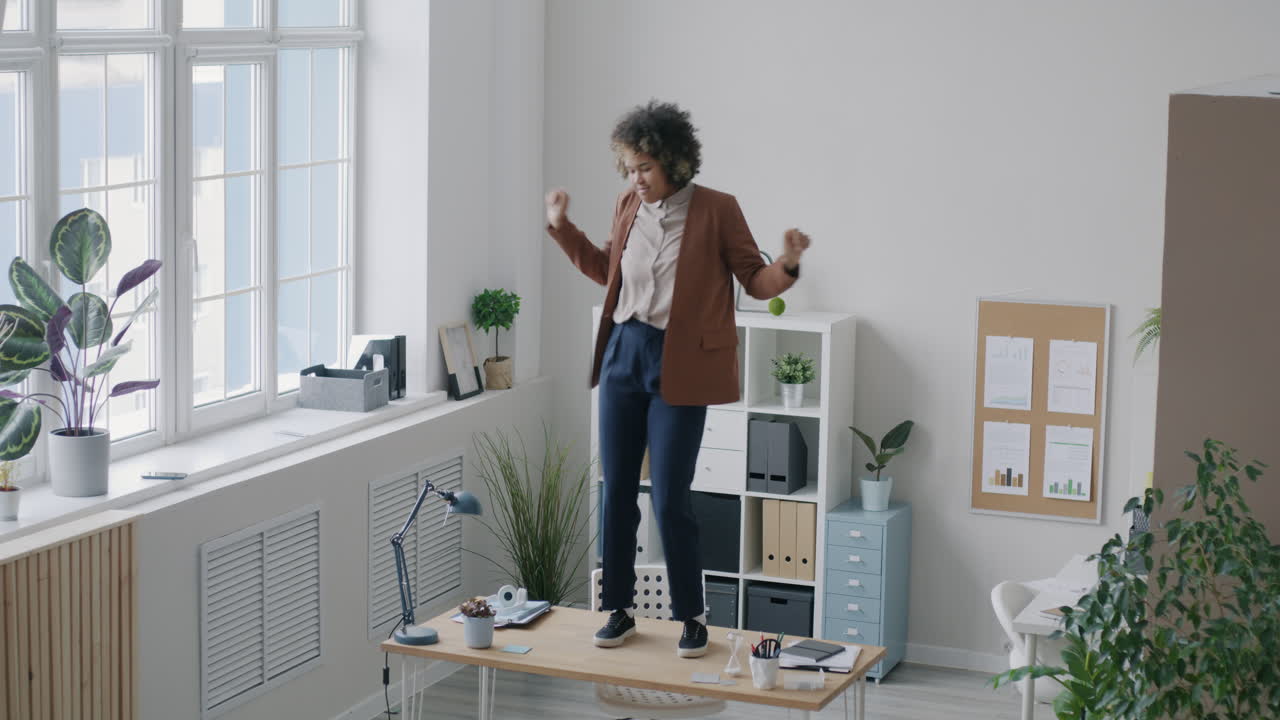 Woman Dancing on a Desk in an Office