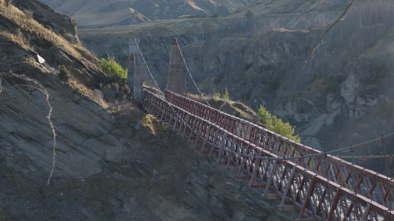 An old bridge above a valley on a sunny summer day at Skippers Canyon, Queenstown, New Zealand.