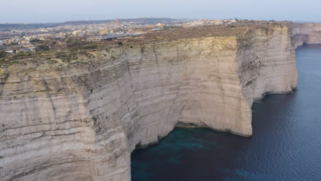 city on high rugged cliffs of gozo island coastline,malta,aerial shot