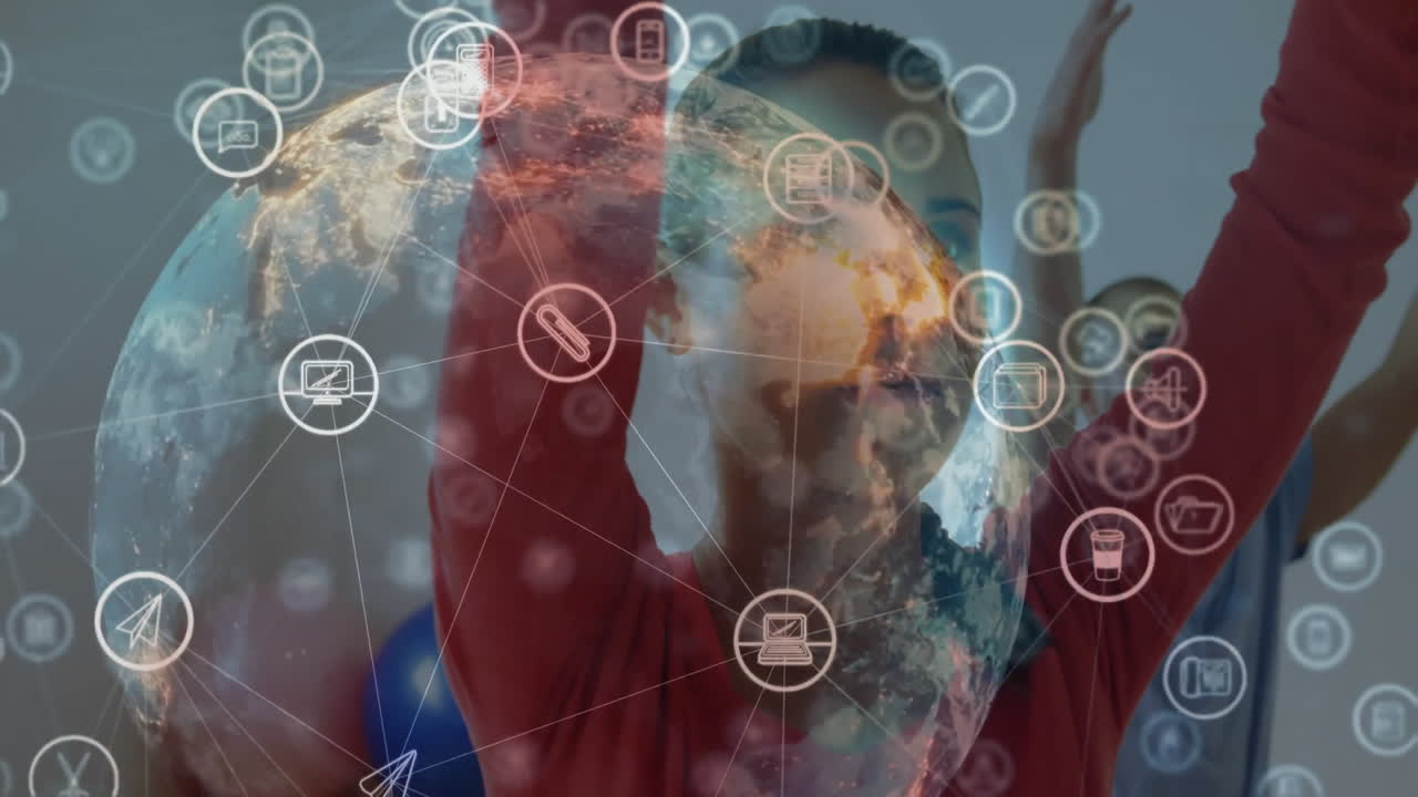 man and woman raising arms overhead in fitness studio, interacting with digital globe network icons