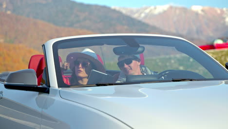 couple enjoying a scenic drive in a convertible