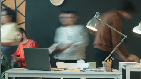 time lapse of diverse colleagues working in modern office