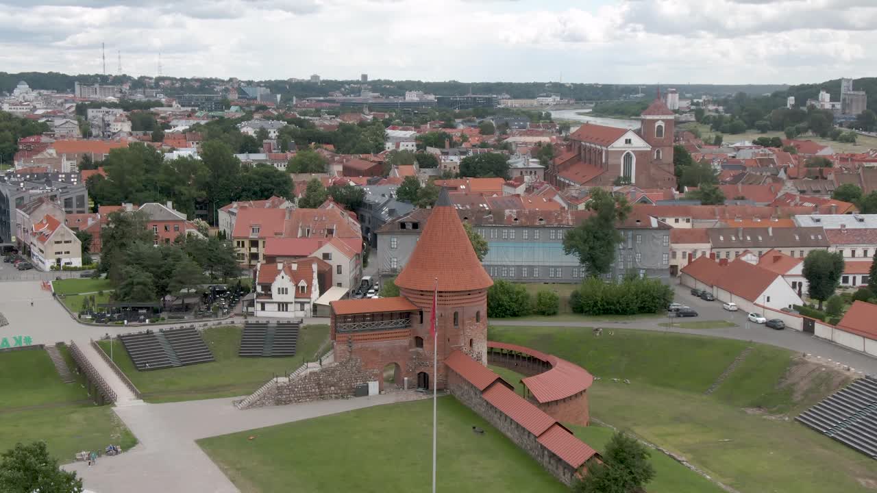 Aerial drone shot of Kaunas Castle (Kauno Pilis) with skyline of Kaunas city in the background. City panorama