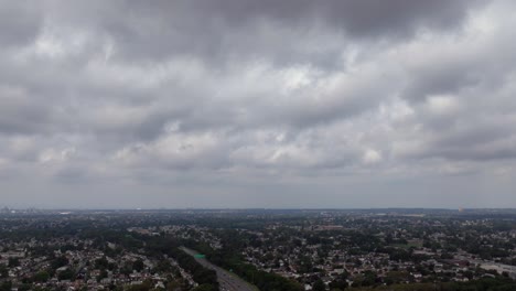 An-aerial-hyperlapse-over-a-highway-on-Long-Island,-New-York-on-a-cloudy-day