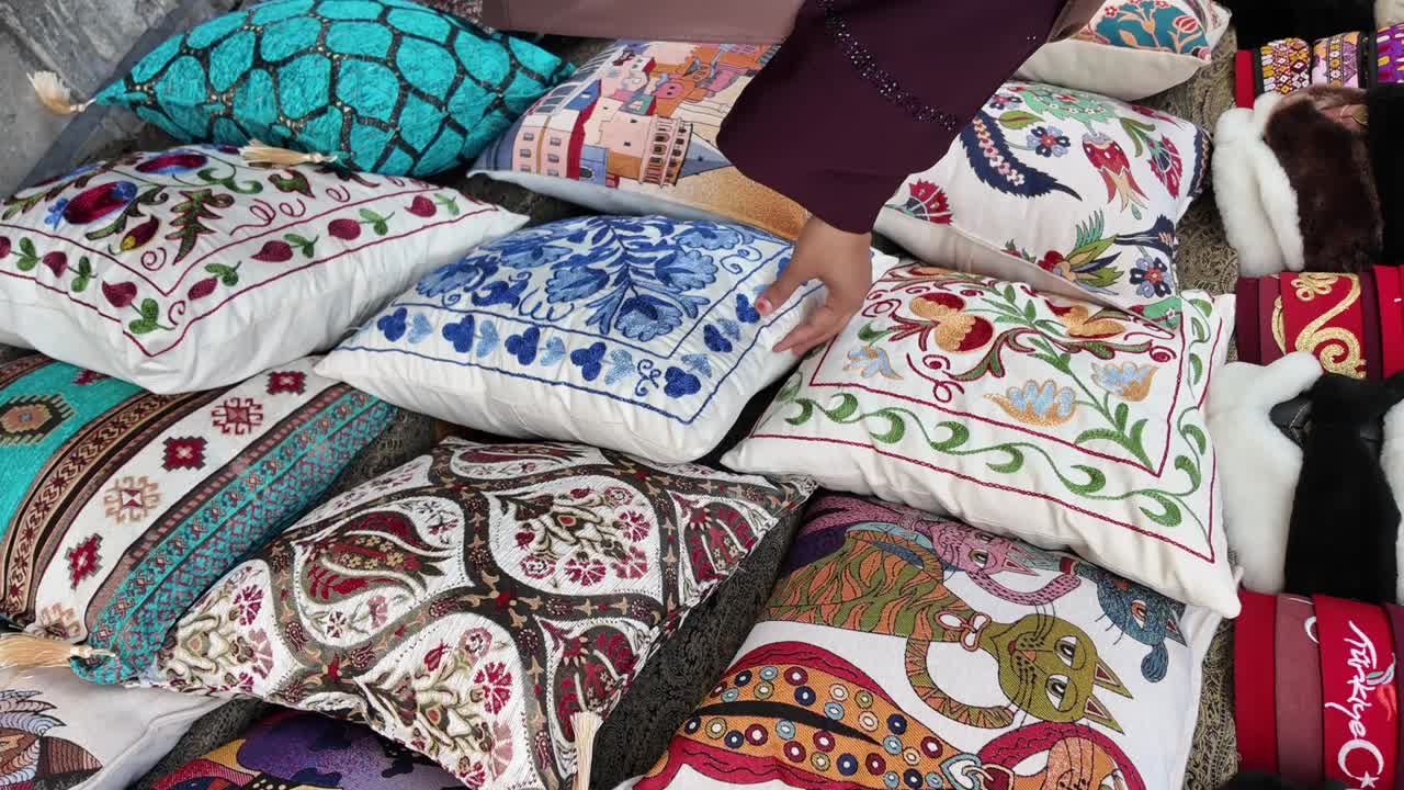 A vibrant collection of decorative embroidered pillows in a market