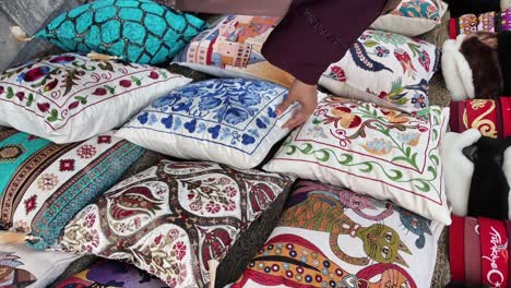 a vibrant collection of decorative embroidered pillows in a market