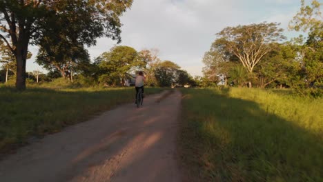 Woman-Rides-Bike-On-The-Nature-Aerial-Fligh