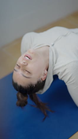 woman practicing seated backbend yoga pose