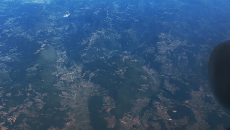 aerial view of mountains and countryside from airplane window