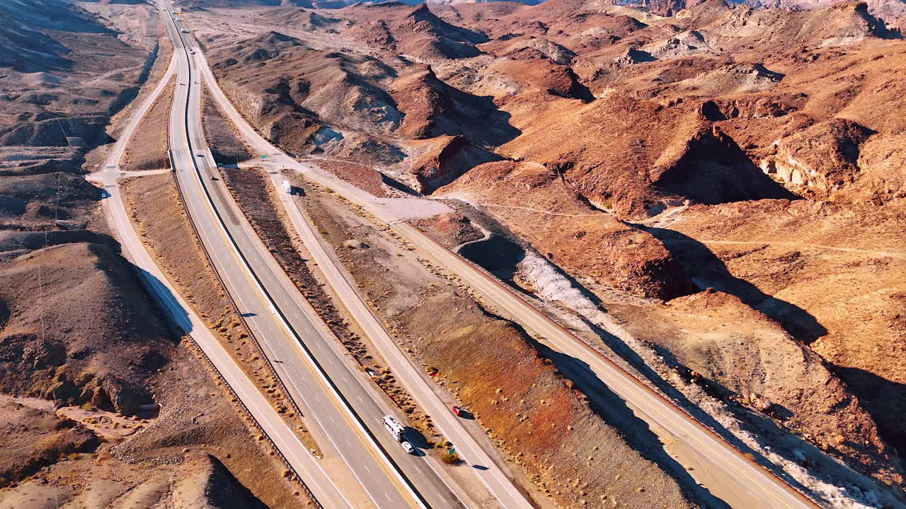 Several highways in the deserted landscape. Cars go by the roads. Aerial perspective on the arid scenery of Arizona, USA