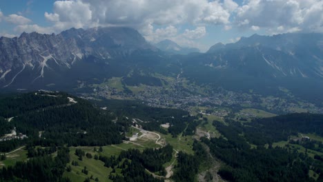 Aerial-Shot-Of-Beautiful-Cortina-Surrounded-By-High-rise-Dolomites-Mountains-,-Italy