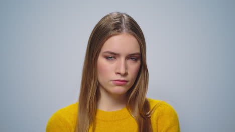 Closeup-dissatisfied-female-model-thinking-on-grey-background-in-studio.