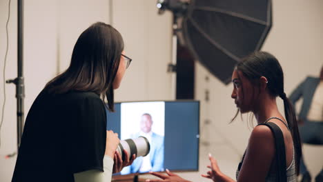 a photographer taking photos of a model in a studio