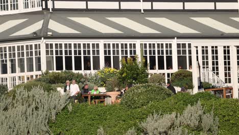 people eating and walking in hotel garden