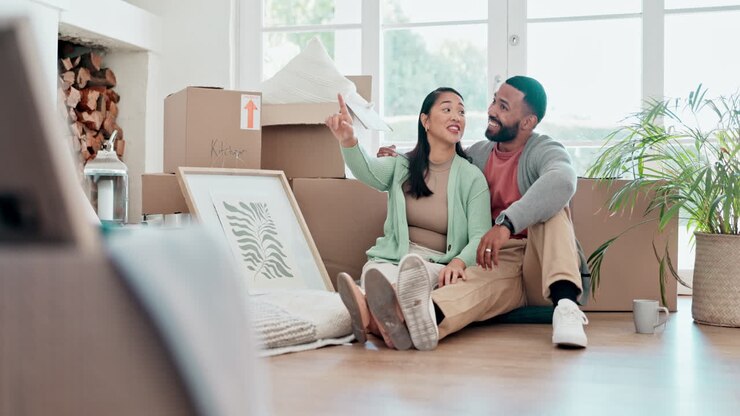 Happy couple, boxes and relax in new home