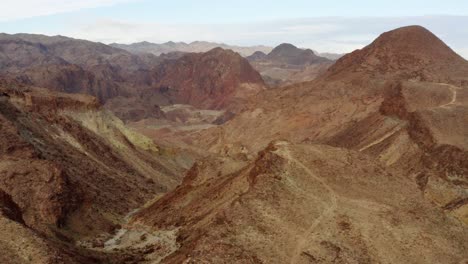 aerial view overlooking layers of rocky erosion shapes in the highlands of kingman, usa - circling, drone shot