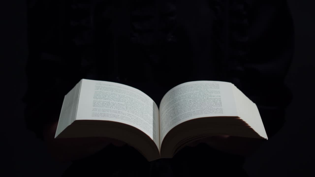Woman Opening a Dusty Book