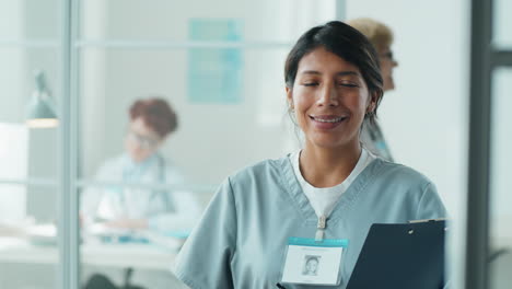 Portrait-of-Smiling-Hispanic-Nurse-in-Clinic