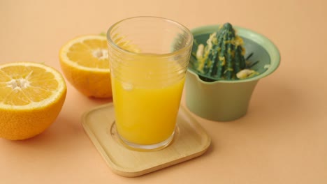 freshly squeezed orange juice with oranges and a juicer