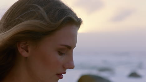 portrait of beautiful woman enjoying calm seaside at sunset exploring spirituality looking up praying contemplating journey relaxing on beach