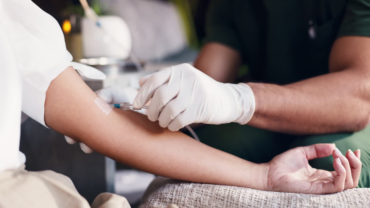 Medical Professional Administering IV Drip to Patient's Arm
