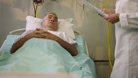 an elderly patient in a hospital bed being attended by a doctor