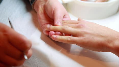 nail technician giving customer a manicure