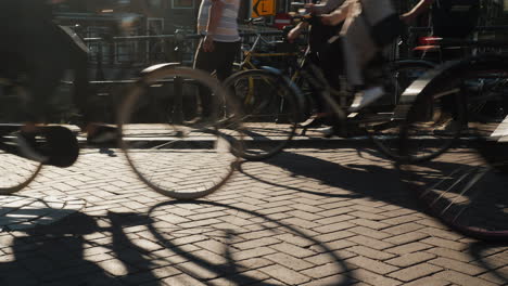 bicycles and pedestrians on narrow bridge in amsterdam