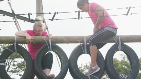 Female-friends-enjoying-exercising-at-boot-camp-together