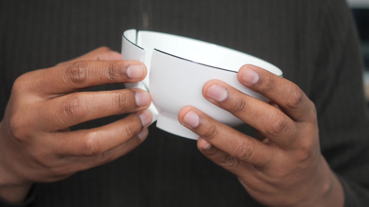 Close Up of Hands Mending a Broken Ceramic Bowl