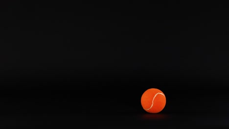 tennis ball moving across a dark background