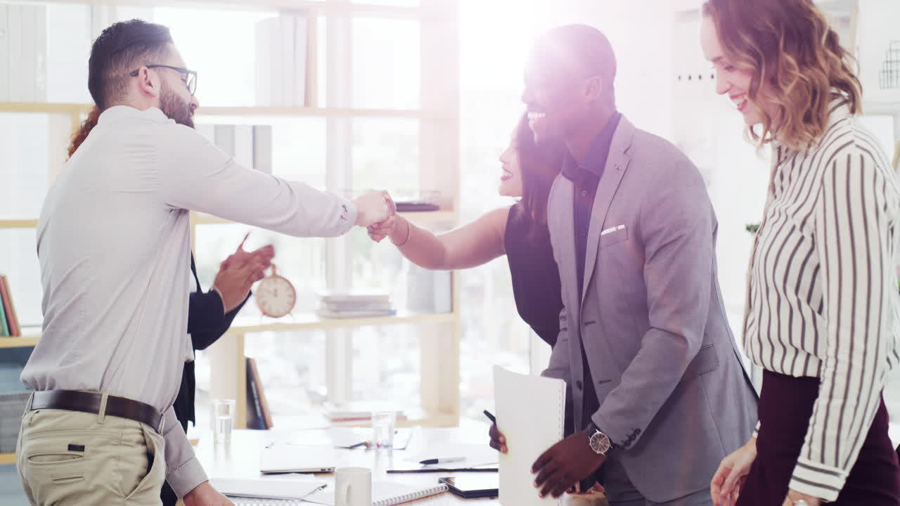 Teamwork, handshake and happy business people