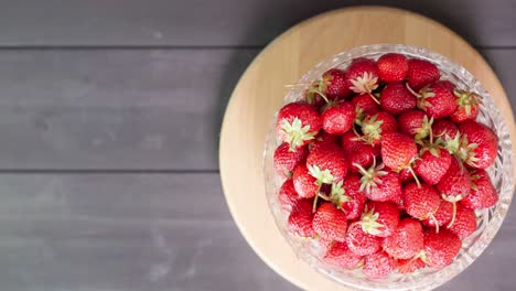 strawberries in a bowl on a wooden background