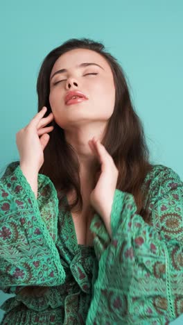 upset woman suffering from headache in blue studio