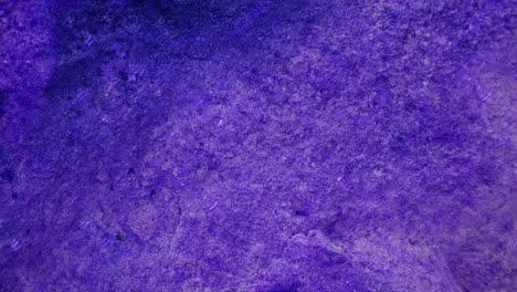 4k rain drop on heavy hard purple granite stone tile surface of cave for interior wallpaper