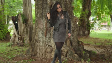 at a tropical park in the caribbean, a woman in a jacket and boots is enjoying her day