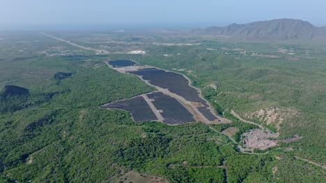 View-From-Above-Of-Solar-Farm-Station-With-Lush-Foliage-In-Fog