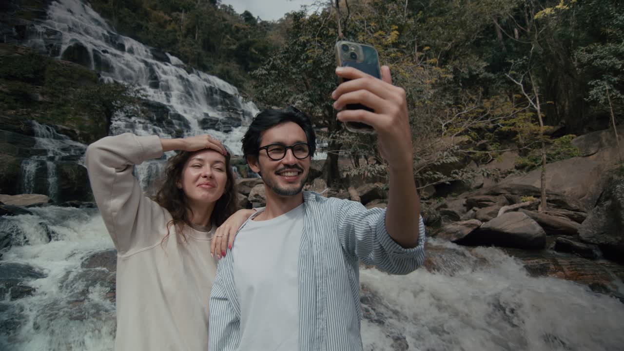 Couple Taking Selfie at Waterfall