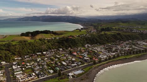 high-quality 4k drone footage captures a beautiful backwards-flying shot over the rugged kaikoura coastline, revealing the majestic ocean and landscape of new zealand's south island