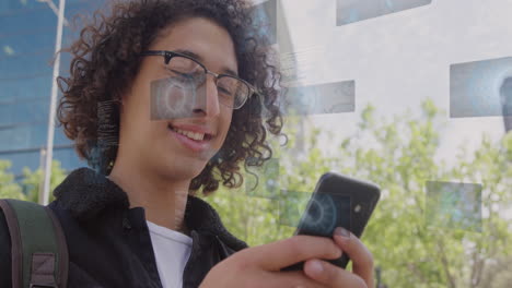 animación de pantallas digitales con procesamiento de datos sobre hombre biracial usando teléfono inteligente.