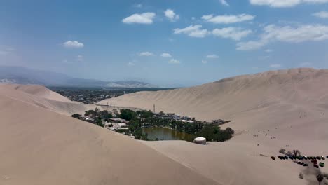 desert oasis huacachina, peru with lake and palms, with great sand dunes in the background