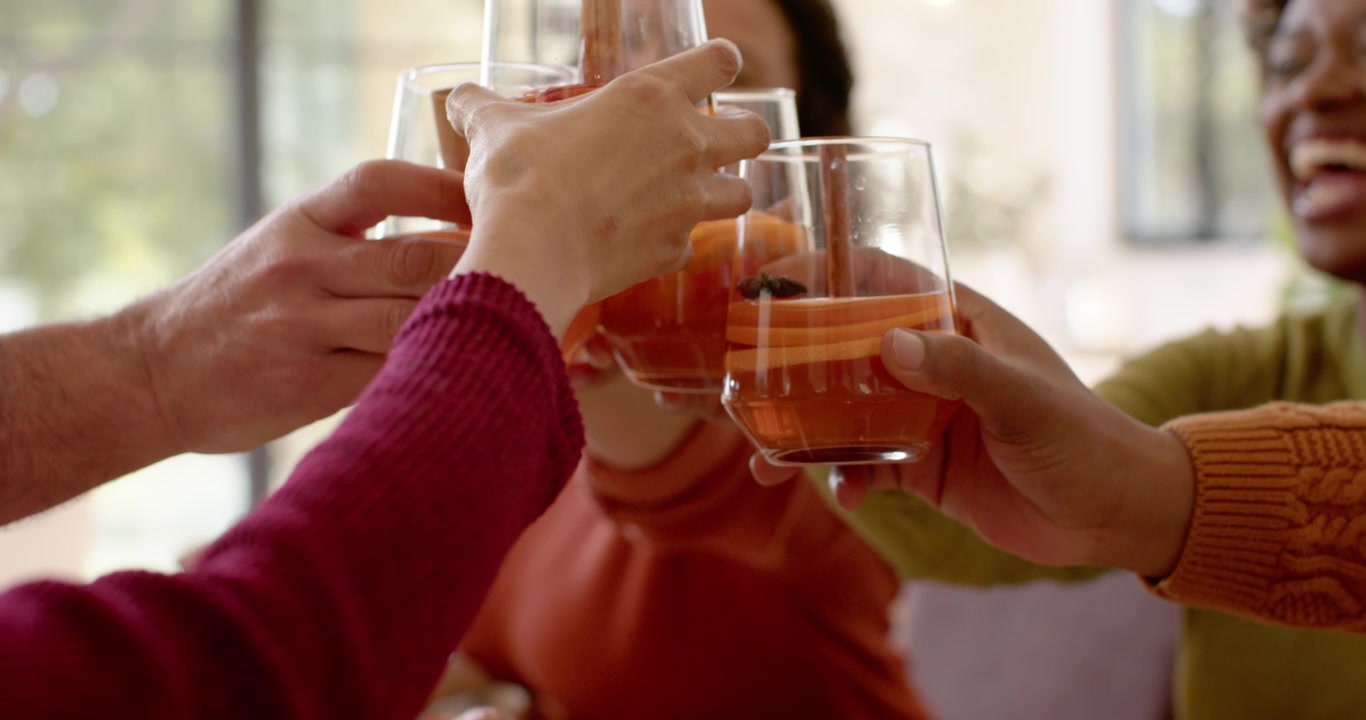 Diverse Friends Toasting with Spiced Cocktails at Home